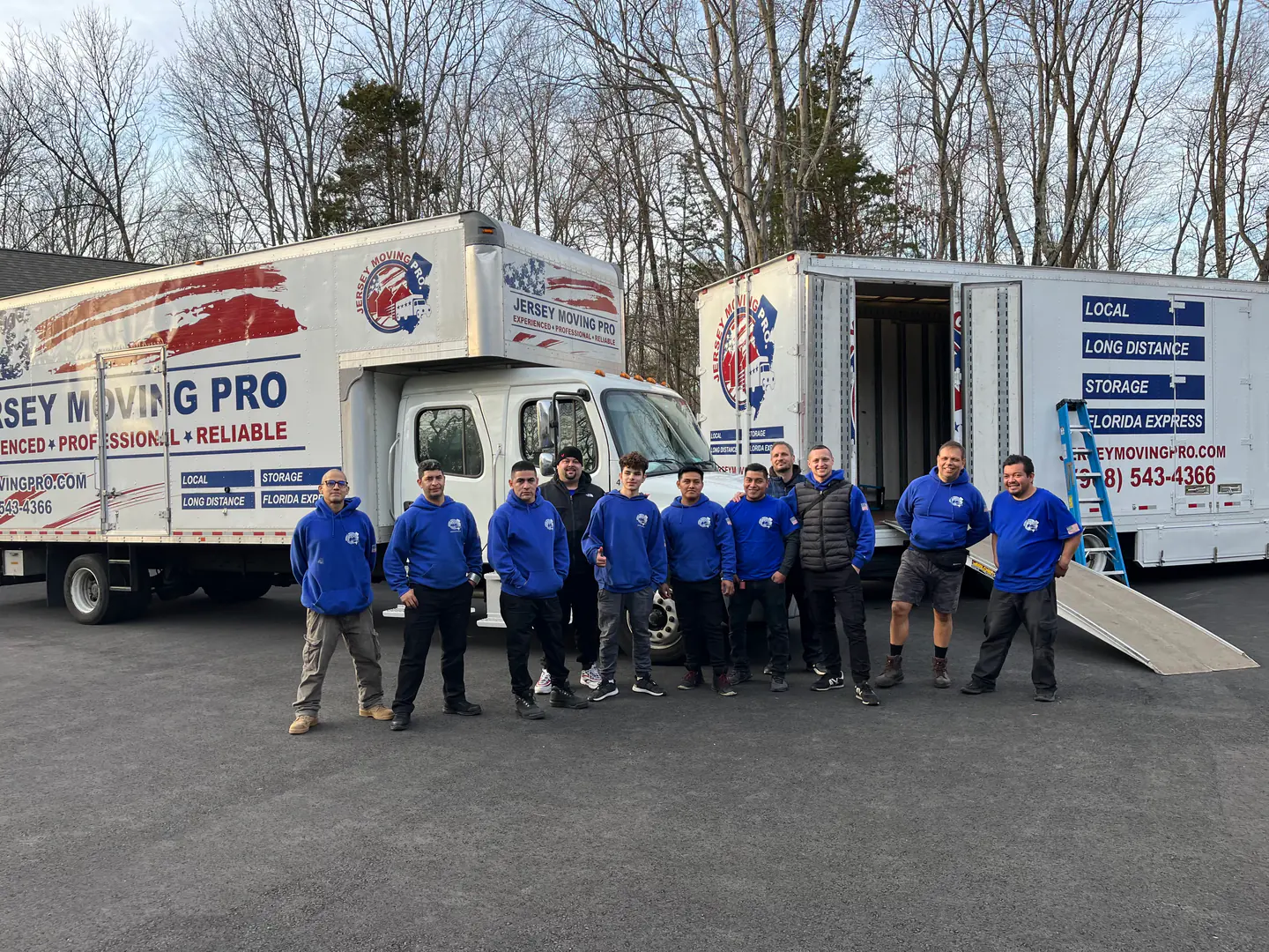 Jersey Moving Pro crew standing beside branded moving trucks